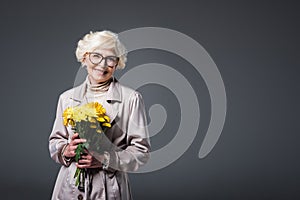 beautiful happy senior woman with yellow flowers,