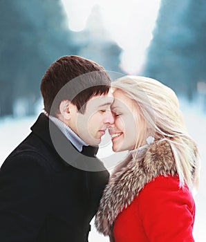 Beautiful happy sensual couple in love in cold sunny winter day