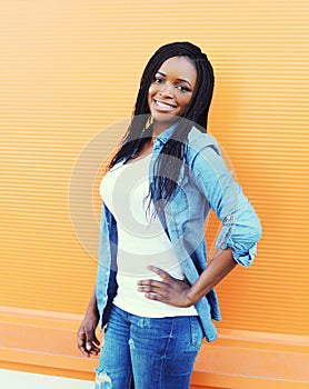 Beautiful happy smiling african woman wearing a jeans clothes