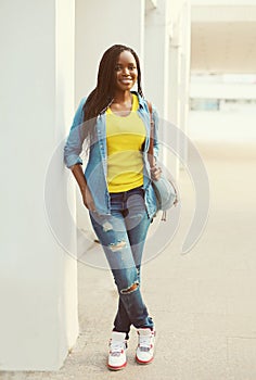 Beautiful happy smiling african woman wearing a jeans shirt