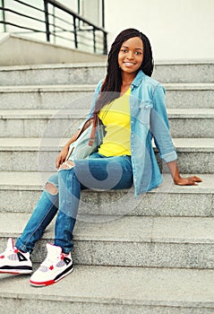 Beautiful happy smiling african woman wearing a jeans shirt