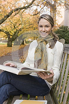 Beautiful, happy, smiling, female woman college university student studying with books on campus