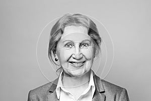 Beautiful happy smiling friendly optimistic senior woman black and white portrait. Lady 60 s years old
