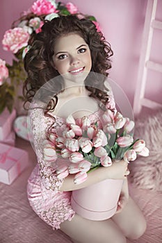 Beautiful happy smiling girl with curly hair, teen with flowers