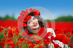 Beautiful happy smiling teen girl portrait with red flowers on h