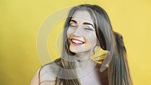 Beautiful happy surprised woman with emotion of scare on yellow background 4K