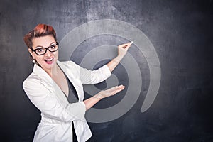 Beautiful happy teacher with piece of chalk