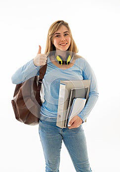 Beautiful happy teenager student girl showing thumbs up