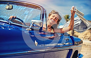 Beautiful happy woman in a car