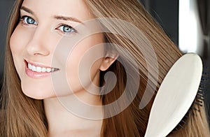 Beautiful happy woman combing her long hair
