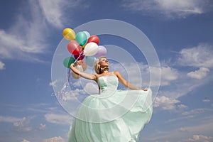 Beautiful, happy woman dancing with balloons