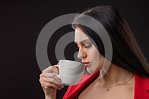 Beautiful happy woman drinking a cup of coffee
