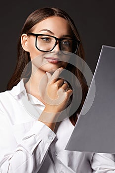 beautiful happy woman in glasses looking at paper. business lady with documents