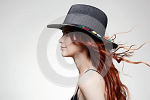 Beautiful happy woman in Hat, with curly long red hair