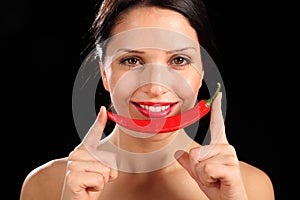 Beautiful happy woman holding red chili pepper