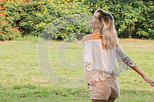 Beautiful happy woman laughing and enjpying in the park