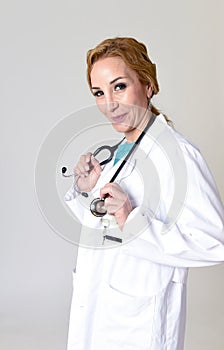 Beautiful and happy woman md doctor or nurse posing smiling cheerful with stethoscope