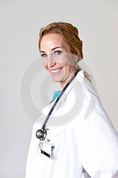 Beautiful and happy woman md doctor or nurse posing smiling cheerful with stethoscope