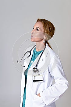 Beautiful and happy woman md doctor or nurse posing smiling cheerful with stethoscope