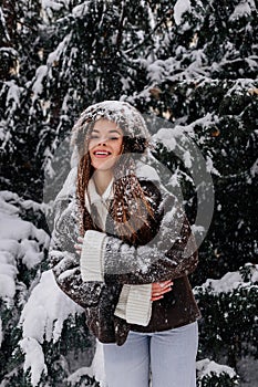 Beautiful happy woman portrait at snowy forest