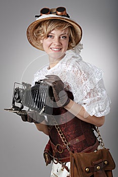 Beautiful happy woman with retro camera.