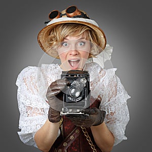 Beautiful happy woman with retro camera.