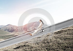 Beautiful happy woman riding downhill