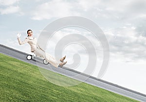 Beautiful happy woman riding downhill