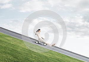 Beautiful happy woman riding downhill