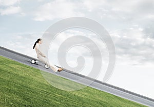 Beautiful happy woman riding downhill