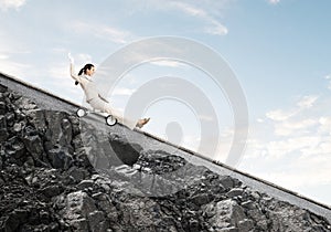 Beautiful happy woman riding downhill