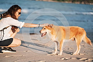 Beautiful Happy Woman Running With Her Dog. Girl Enjoying Summer Holidays Vacations, Having Fun With Her Pet. Summertime Concept