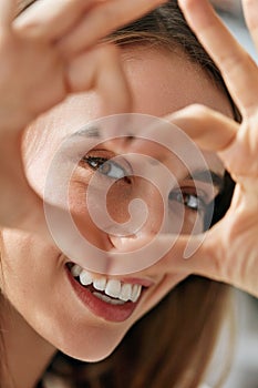 Beautiful Happy Woman Showing Love Sign Near Eyes.