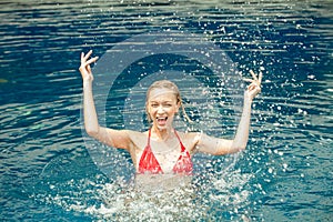 Beautiful Happy woman splashing water in swimming pool ,lady in