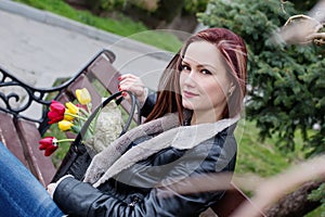 Beautiful happy woman with tulips in a bag