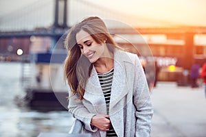 Beautiful happy woman walking near East River in New York City