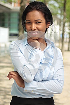 Beautiful happy young black woman outside in the park