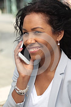 Beautiful happy young black woman outside in the park