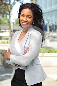 Beautiful happy young black woman outside in the park