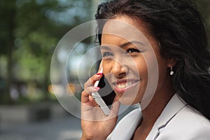 Beautiful happy young black woman outside in the park