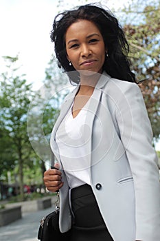 Beautiful happy young black woman outside in the park