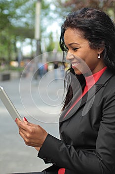 Beautiful happy young black woman outside in the park