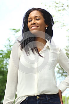 Beautiful happy young black woman outside in the park