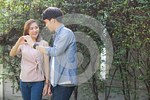 Beautiful happy young couple fun making gesture heart shape with hand outdoor together