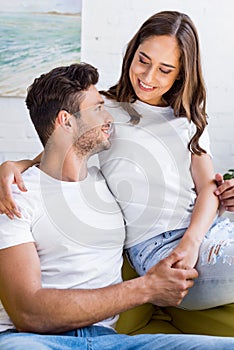 beautiful happy young couple holding hands and smiling each other