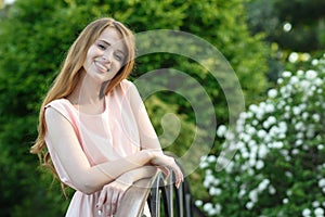 Beautiful and happy young girl walks in the park and enjoys life