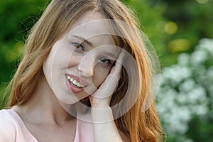 Beautiful and happy young girl walks in the park and enjoys life