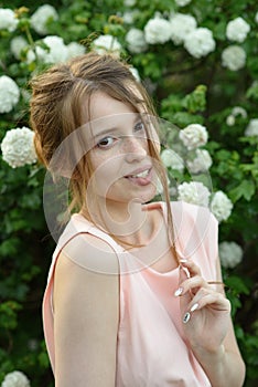 Beautiful and happy young girl walks in the park and enjoys life