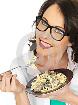 Beautiful Happy Young Hispanic Woman Eating a Plate of Vegetarian Linguine With Spinach and Mushrooms