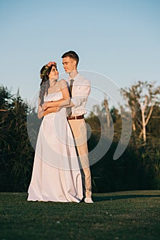 beautiful happy young wedding couple embracing and smiling each other
